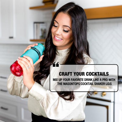 woman shaking cocktail shaker with red liquid and ice inside