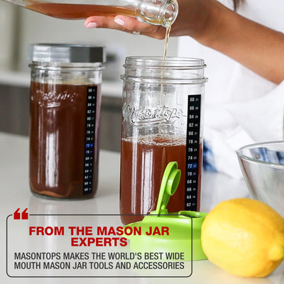 kombucha being poured to a mason jar