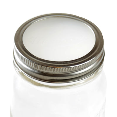 silicone disk on a mason jar, secured with metal ring