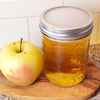 silicone disc on a mason jar with apple juice, secured with metal ring