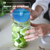 mason jar with fermented brussel sprouts and hand putting an airlock on the jar