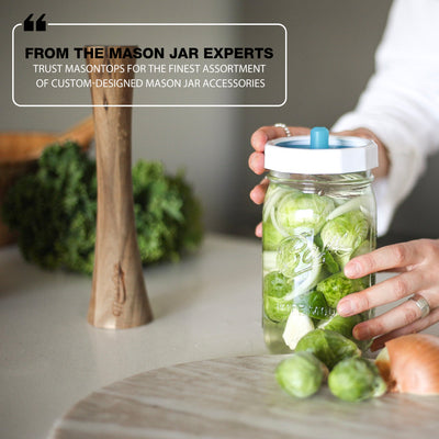 fermented brussel sprouts in the jar with a hand screwing on the lid